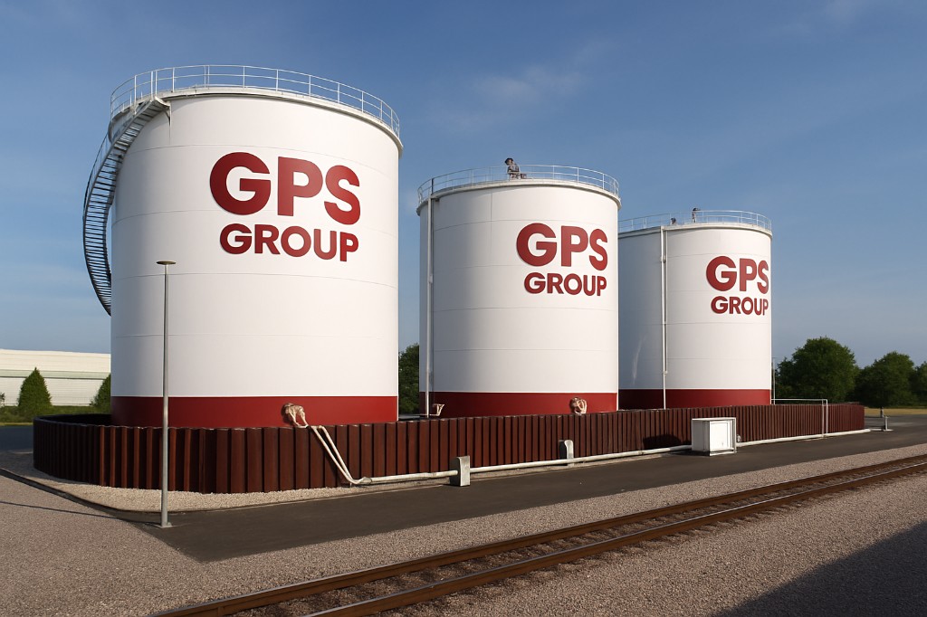 Three white storage tanks with red bases and red GPS Group lettering.